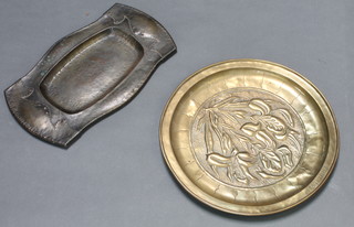 An Art Nouveau shaped copper twin handled tray 13" x 8" and a Victorian circular embossed charger with floral decoration marked Violet 1894 12 1/2" 