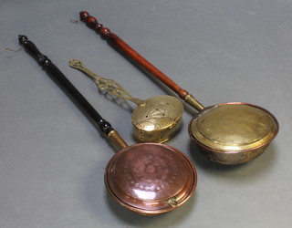 An oval Victorian pierced brass chestnut roaster (f and r) together with 2 copper and brass warming pans with turned wooden handles