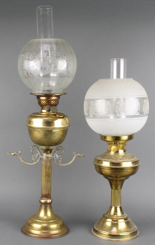 A brass oil lamp raised on a fluted column with etched glass shade (reservoir dented) and 1 other brass oil lamp with etched glass shade