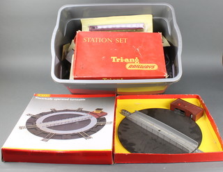A Triang R45 turn table boxed, a Hornby OO gauge turn table boxed, a Triang R81 station set and various buildings and track 