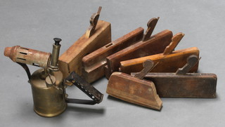 A brass blow lamp and 6 wooden moulding planes