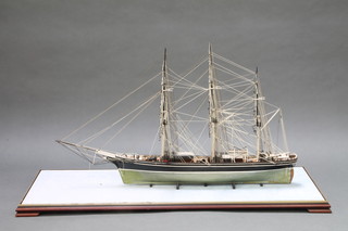 A model of Cutty Sark contained in a glazed cabinet 28"h x 42"w x 17 1/2"d 