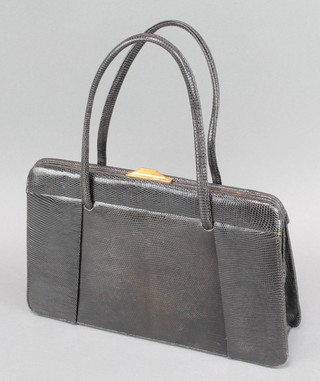 A lady's black "lizard skin" handbag with gilt metal mounts 8" x 11" x 3" 