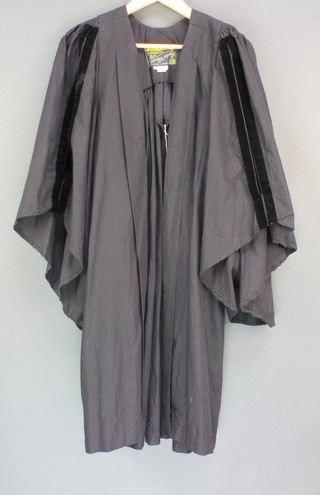 A Cambridge University undergraduates black gown with velvet trim by the outfitters  Ryder & Amies of Cambridge
