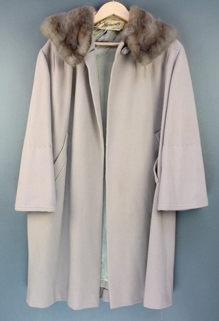 A Felix-Fashions grey "wool" coat with grey fur collar, retailed by Harrods (some light staining and very slight moth) together with a simulated Persian lamb coat with fur collar retailed by Harrods