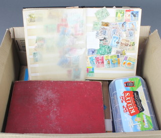 A red stockbook of various World stamps and a collection of loose stamps etc 
