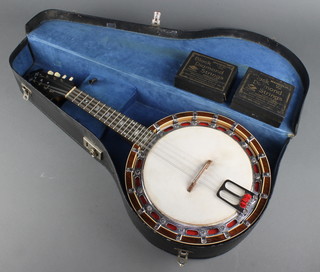 An 8 stringed mandolin banjo together with a collection of black diamond strings contained in a fibre case