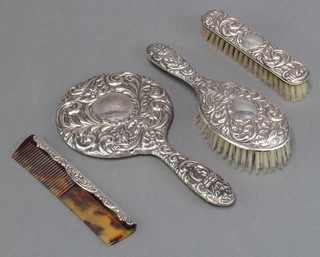 A silver backed dressing table set comprising hand mirror, hair brush, clothes brush and comb Birmingham 1917 