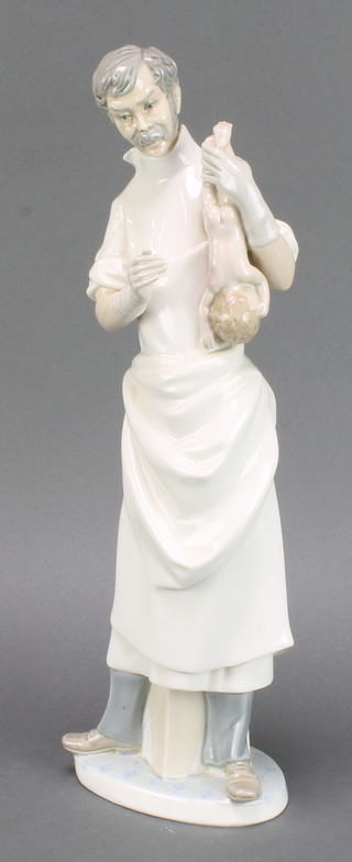 A Lladro figure of an Obstetrician holding a baby, 14" 
