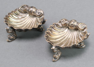 A pair of Victorian silver table salts in the form of shells with dolphin supports London 1868, 60 grams