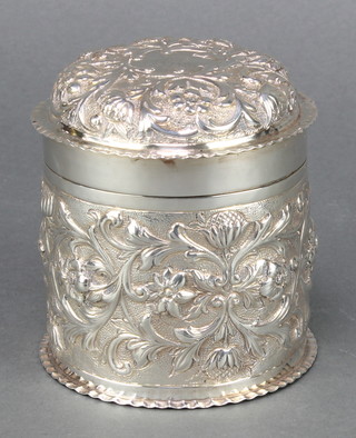 A Victorian circular silver repousse silver box and cover decorated with flowers London 1895, 178 grams 