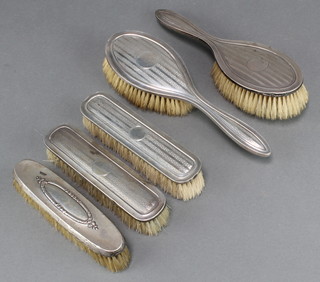 A silver engine turned 4 piece dressing table set comprising 2 clothes brushes and 2 hair brushes Birmingham 1916 and 1 odd clothes brush