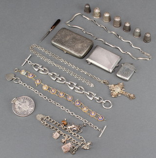 A silver charm bracelet, pendant and chain, vesta case, coin pendant, 3 silver bracelets, a necklace, 7 thimbles, cigarette case and match sleeve, 306 grams 
