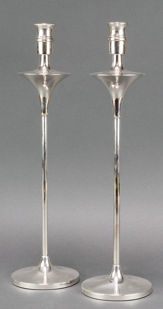 A pair of stylish silver candlesticks with candle caps London 1962, 14" 