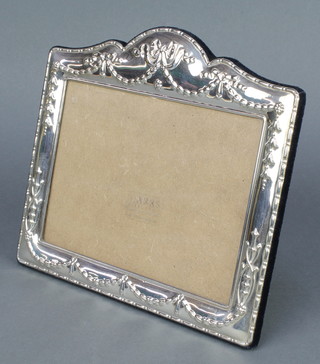 A sterling silver repousse photograph frame decorated with swags and ribbons 8 1/2" x 7 1/2" 