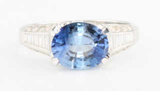 An 18ct white gold oval sapphire and diamond ring, the oval stone approx. 2.15ct with baguette and brilliant cut diamonds approx 0.25ct, size M 