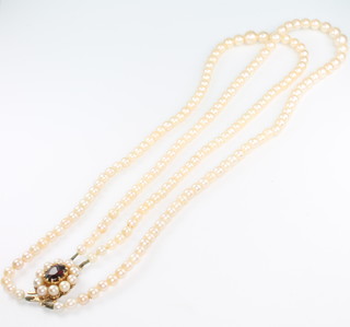 A double strand of graduated cultured pearl necklace with 9ct yellow gold garnet and pearl set clasp 16" 