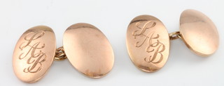 A pair of 9ct yellow gold oval cufflinks with chased monogram, 10 grams