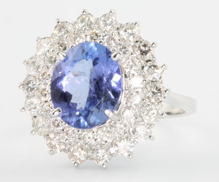 An 18ct white gold tanzanite and diamond oval cluster ring, the centre stone approx. 2.54ct surrounded by brilliant cut diamonds 1.24ct, size N