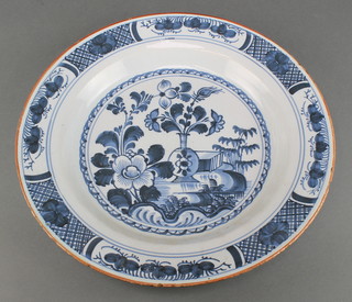 A 19th Century Delft bowl decorated with flowers 13" 