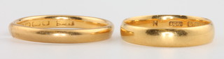 Two 22ct yellow gold wedding bands, size L and O, 5.4 grams
