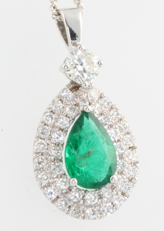An 18ct white gold pear shaped emerald and diamond pendant, the centre stone approx 1.25ct surmounted by a single stone diamond approx. 0.33ct surrounded by brilliant cut diamonds approx 0.97ct 