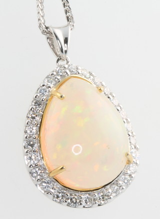 An 18ct white gold pear cut opal and diamond pendant, the centre stone approx. 11ct surrounded by brilliant cut diamonds 1ct, on an 18ct white gold chain