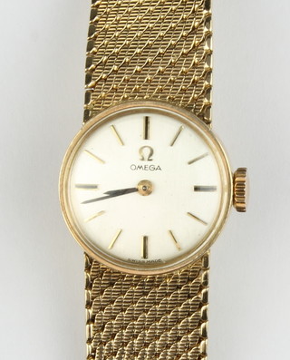 A lady's Omega 9ct gold wristwatch on a 9ct gold mesh bracelet, approx. 29 grams 