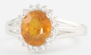 A 14ct yellow gold yellow sapphire and diamond oval cluster ring, the centre stone approx 3ct flanked by brilliant cut diamonds 0.34ct, size M 1/2