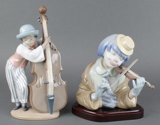 A Lladro figure of a clown playing a violin 5600 7" together with a ditto of a child playing a cello 5004 10" 