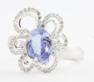 A 14ct white gold tanzanite and diamond ring, the centre stone approx 1.52ct surrounded by brilliant cut diamonds approx 0.37ct size M 1/2 