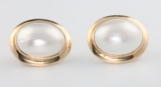 A pair of oval 14ct yellow gold pearl set ear studs 