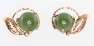 A pair of yellow gold and jade ear studs
