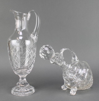 A decanter and stopper with ball feet 11" and a glass ewer with presentation inscription 13" 