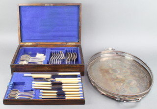 An oak canteen containing a quantity of silver plated cutlery and an oval plated tray 