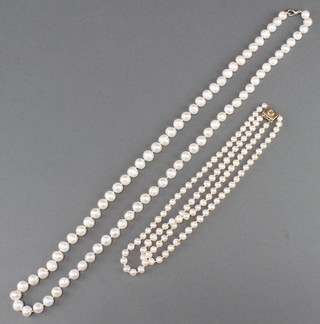 A double strand of cultured pearls with a gold clasp 17" and 1 other string of cultured pearls 36" 