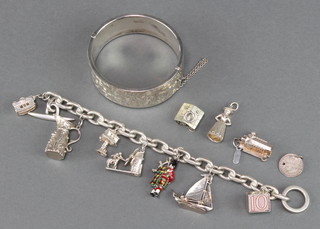 A silver charm bracelet, 4 charms and a silver bangle, 125 grams