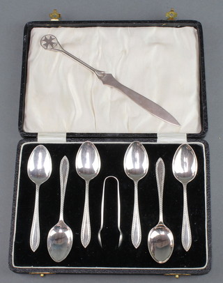 A set of cased silver coffee spoons and nips Birmingham 1932 together with a silver paper knife 