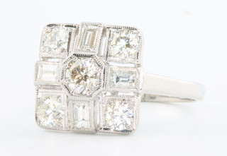 An 18ct white gold Art Deco style brilliant and baguette cut diamond ring, approx 1.25ct size M