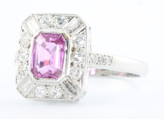 An 18ct white gold pink sapphire and diamond cocktail ring, the sapphire approx 1.10ct, the diamonds 0.5ct size O 1/2