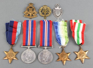 A group of 4 medals comprising 1939-45 Star, Atlantic Star with bar France and Germany, Italy Star, British War medal together with a British War medal ATS cap badge, Royal Army Ordnance Corps cap badge, silver shield shaped watch chain medallion 