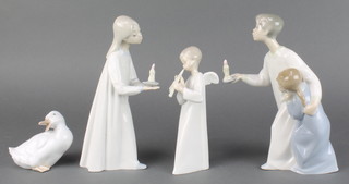A Nao figure of a ghost 3 1/2", a do. of an angel 6 1/2", a girl with chamber stick 7" and 2 children 8" 