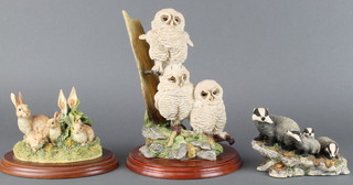 A Border Fine Arts group - Triple Tawny Owlets A5207 by Russell Willis 2004 9 1/2" together with a group of rabbits by Kirsty 1997 5", Badgers RW31 4" by D Walton 