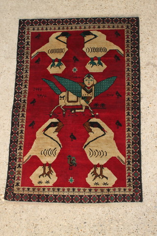 A red ground pictorial Persian rug with birds, mythical winged beast dated 2006 54" x 36" 