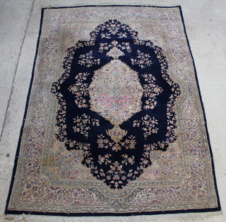 A Persian blue and floral ground carpet with central medallion 122" x 83"  