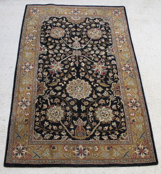 A black and floral ground machine made Indian wool rug 94" x 60"  