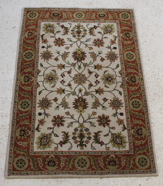 An Indian white ground and floral patterned rug within multi row border 72" x 49" 