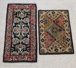 An Indian black ground wool rug with floral field to the centre within a multi row border 48" x 23" and a brown ground ditto with central medallion 36" x 24" 
