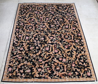 An Indian black ground and floral patterned carpet 140" x 102" 