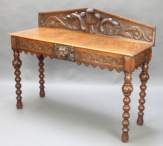 A Victorian carved oak hall table, the raised back with Prince of Wales feathers, fitted 2 short drawers to the front and raised on ring turned supports 42"h x 54"w x 19 1/2"d 